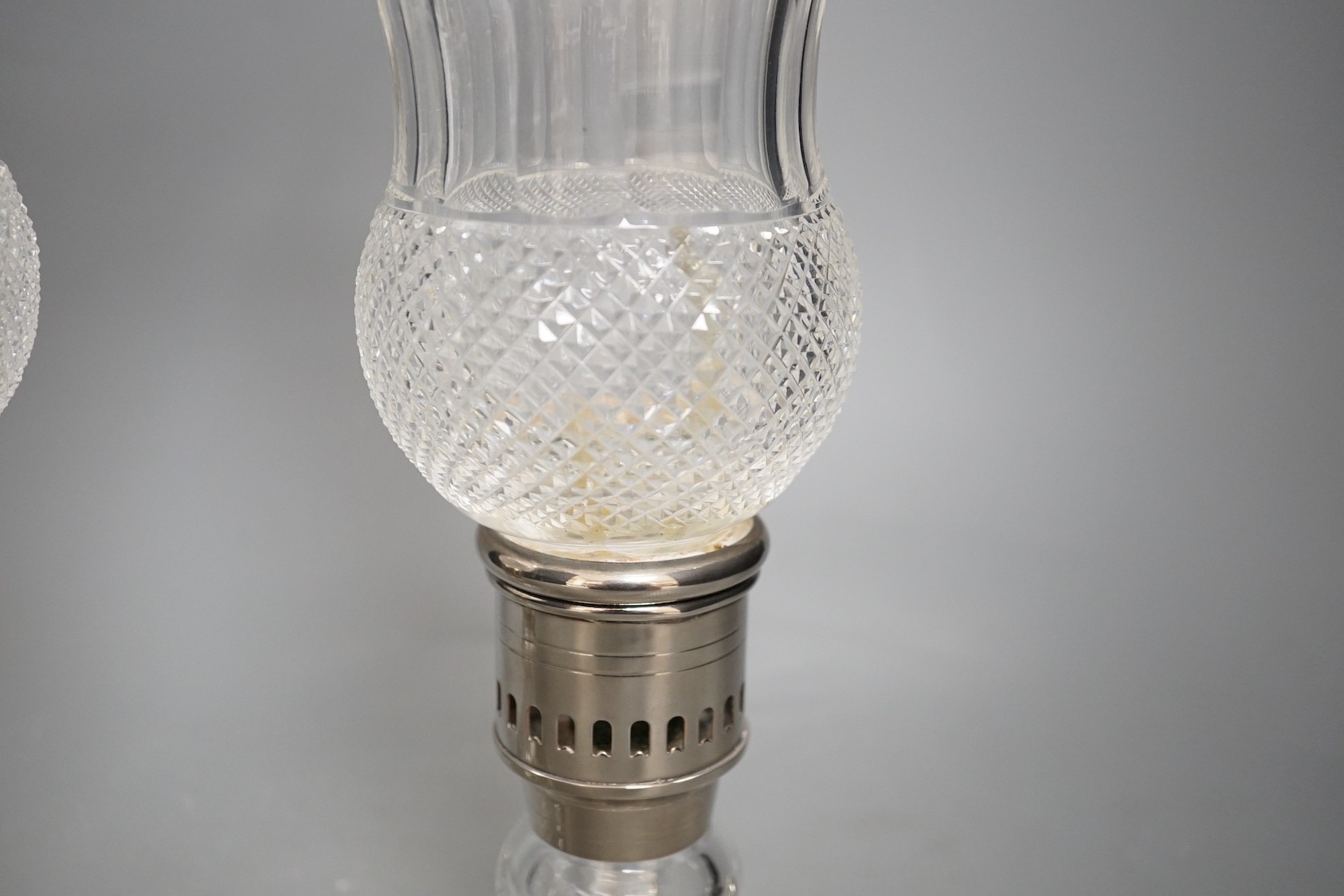 A pair of thistle engraved and cut glass storm lamps - 35cm tall